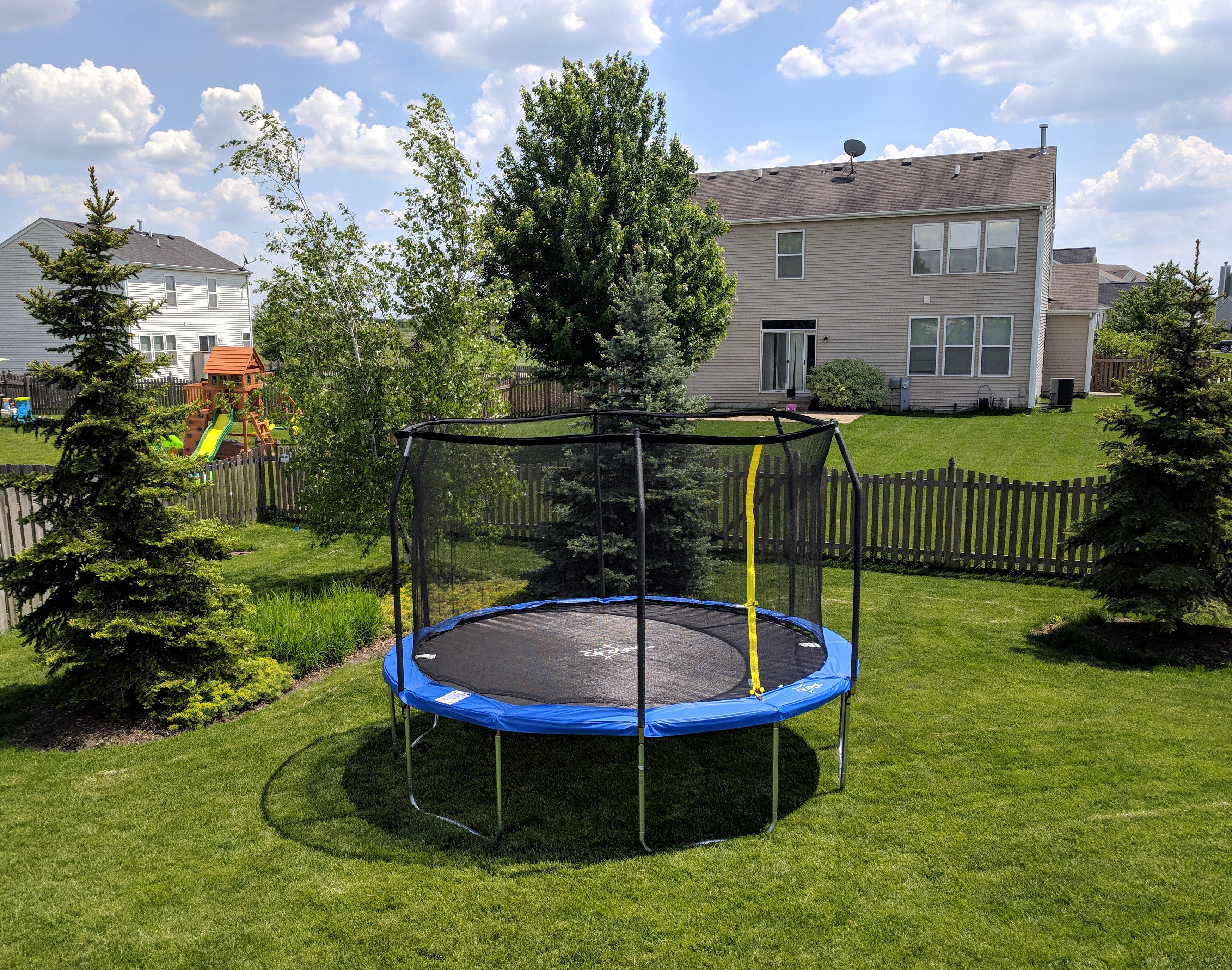 A 15 ft Backyard Jump Round Trampoline in a backyard.